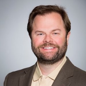 Headshot of a smiling man