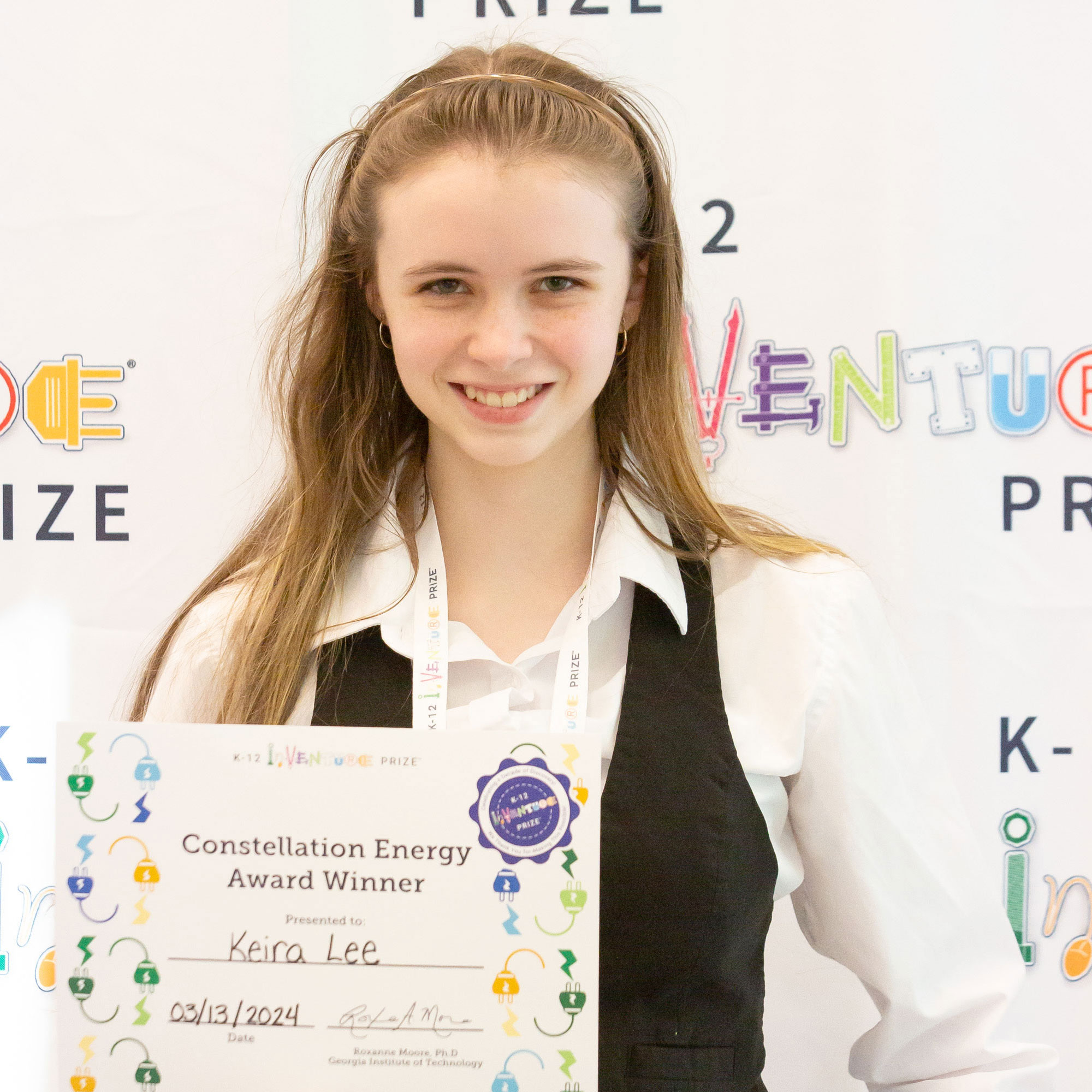 A smiling student holding a certificate