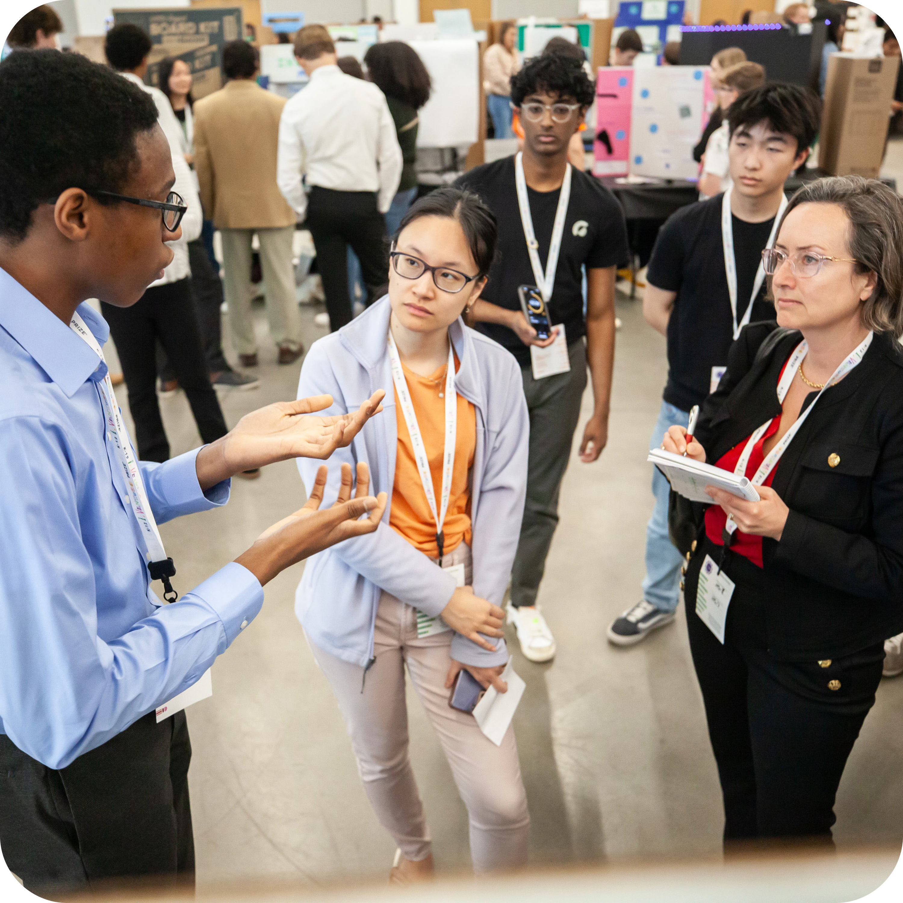 Student speaking with and presenting to two adults